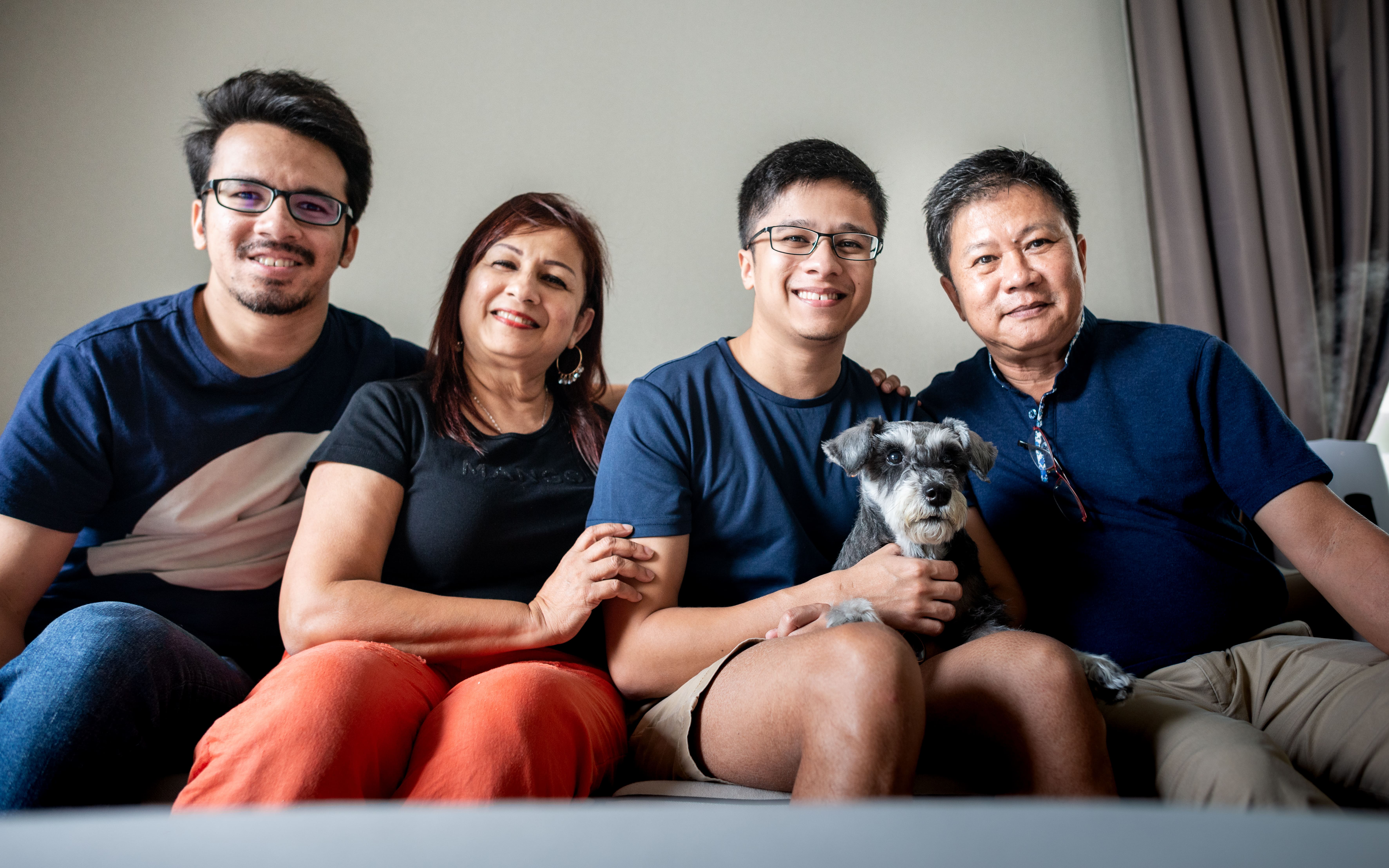 Family posing with dog