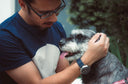 Man looking fondly at schnauzer
